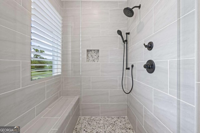 bathroom with a tile shower