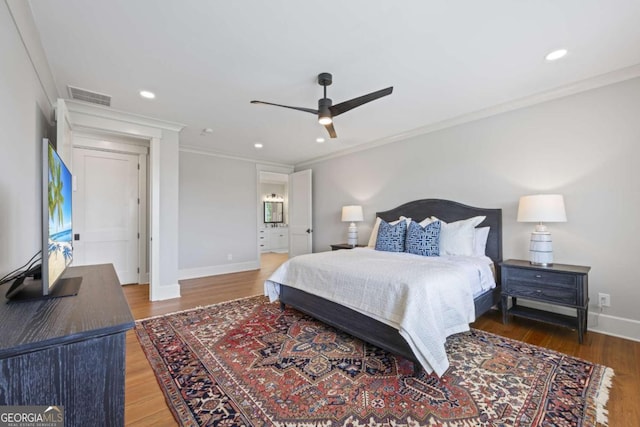 bedroom with ceiling fan, crown molding, and hardwood / wood-style floors