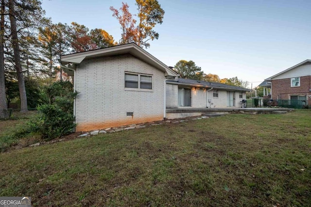 back of house with a lawn