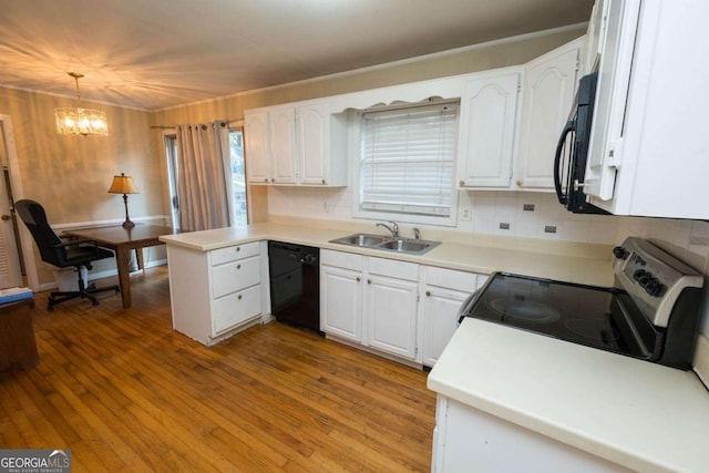 kitchen with sink, black appliances, pendant lighting, a notable chandelier, and white cabinetry