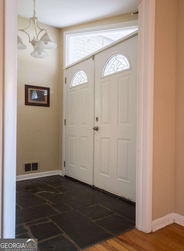 foyer entrance with an inviting chandelier