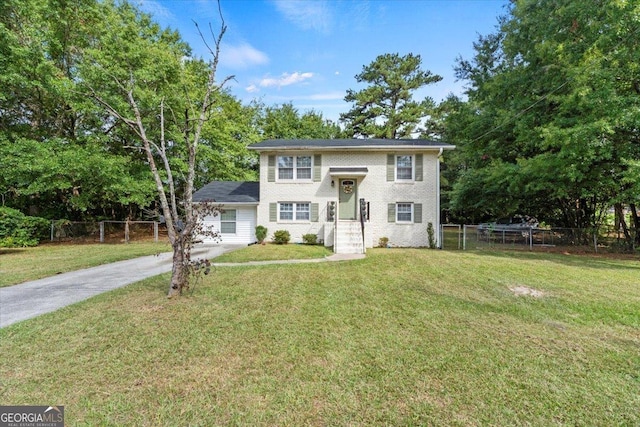 bi-level home with a front lawn