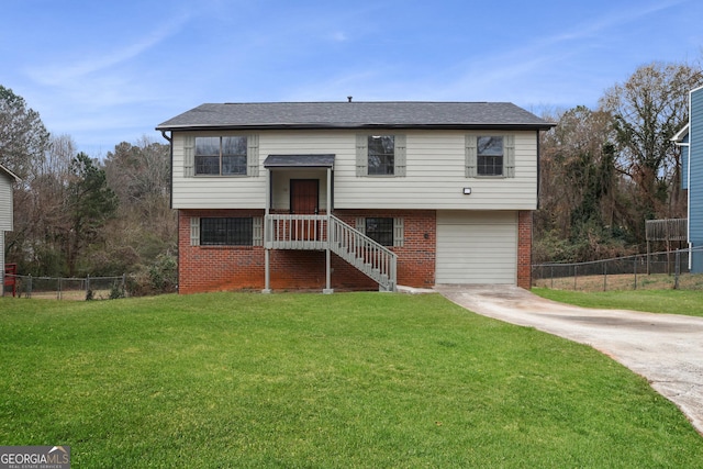 bi-level home featuring a front lawn and a garage