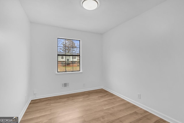 spare room featuring light wood-type flooring