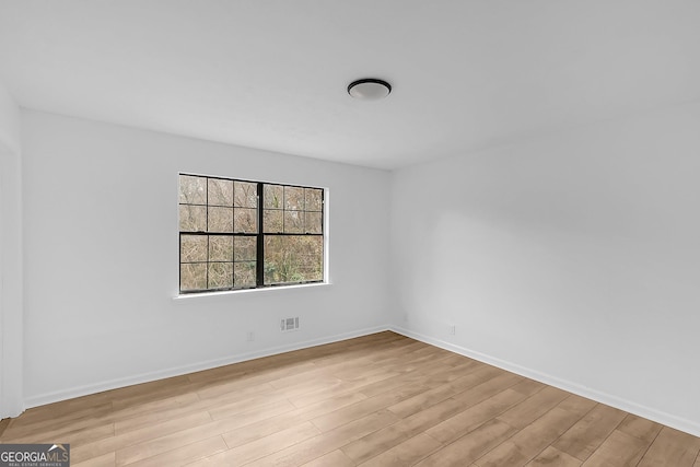 empty room with light hardwood / wood-style flooring