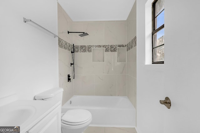 full bathroom with tiled shower / bath, vanity, and toilet