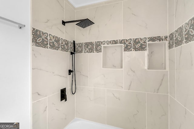 bathroom with tiled shower