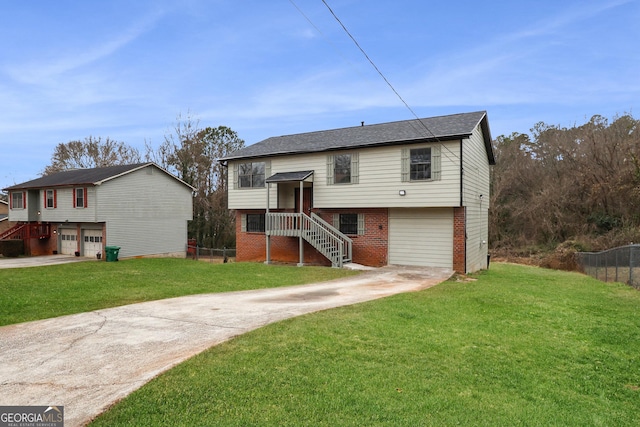 raised ranch with a garage and a front lawn