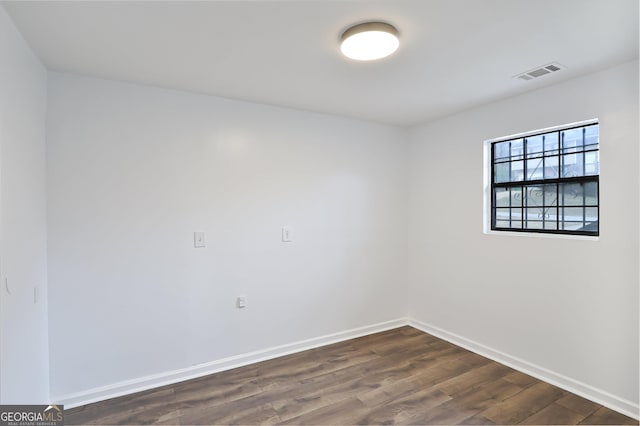 unfurnished room with dark hardwood / wood-style floors