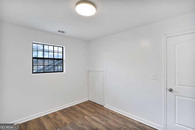 unfurnished room with dark hardwood / wood-style floors