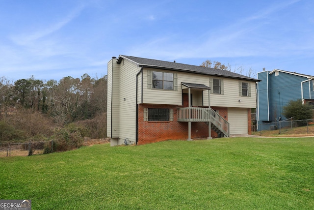 back of property with a lawn and a garage