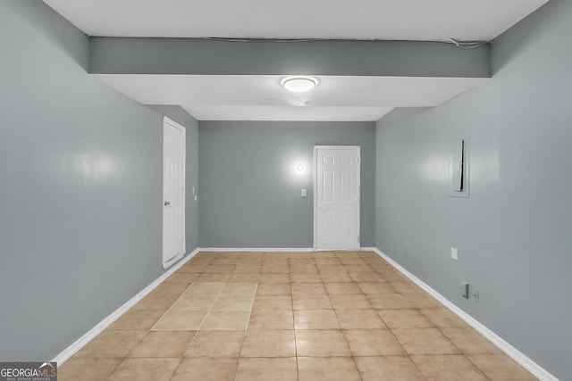 unfurnished room featuring light tile patterned floors