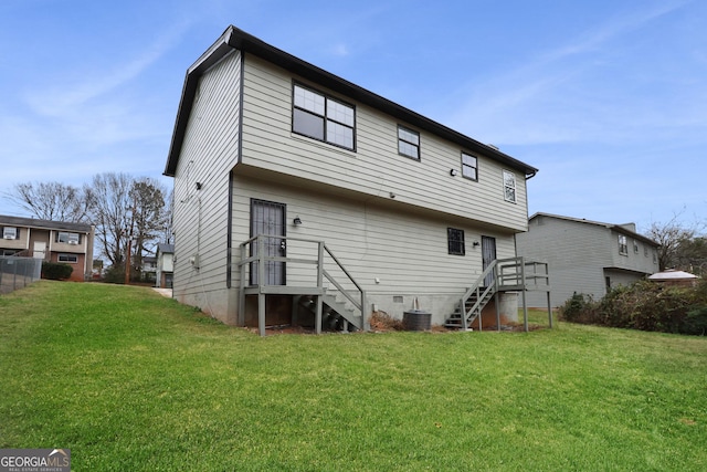 rear view of property with central AC unit and a lawn