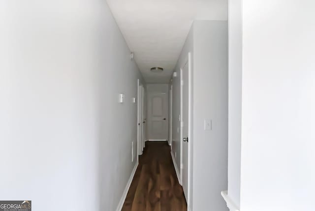 corridor with dark hardwood / wood-style floors