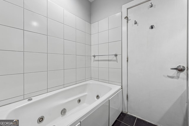 bathroom with a tub and tile patterned floors