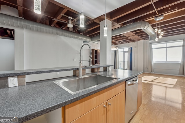 kitchen with stainless steel dishwasher, decorative light fixtures, light wood-type flooring, ceiling fan, and sink