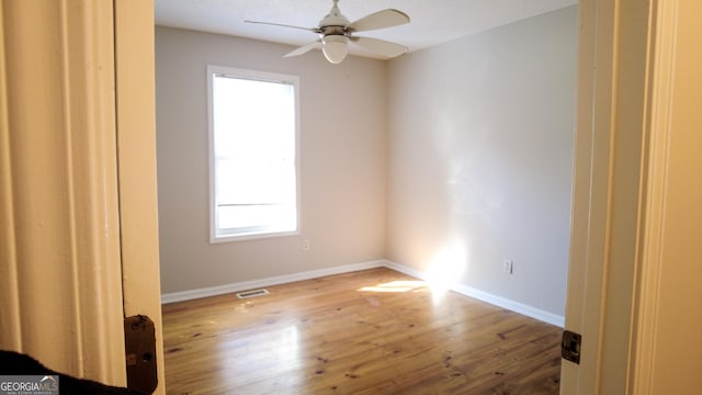 unfurnished room featuring light wood-type flooring and ceiling fan