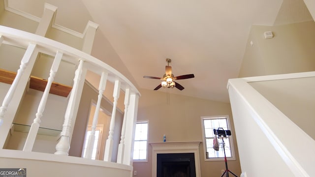 unfurnished living room with vaulted ceiling and ceiling fan