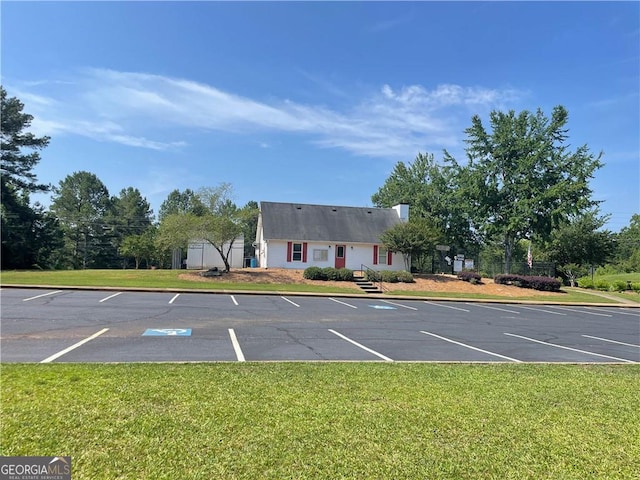 view of parking featuring a yard