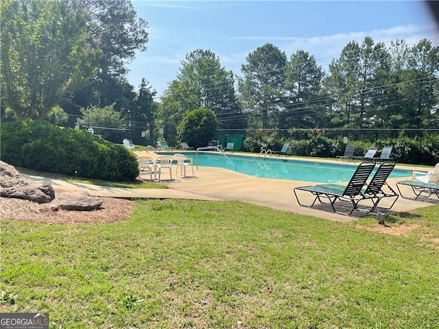 view of swimming pool with a lawn and a patio area