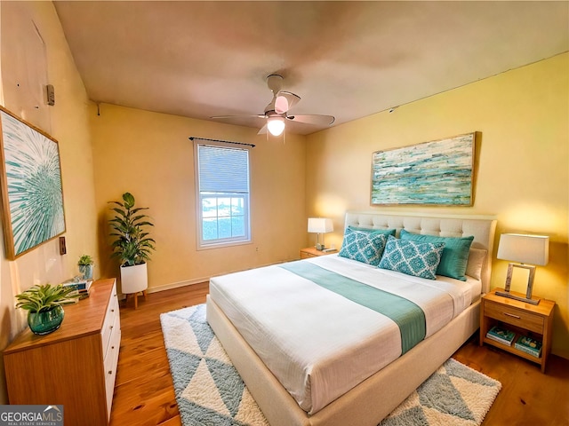 bedroom with ceiling fan and wood-type flooring