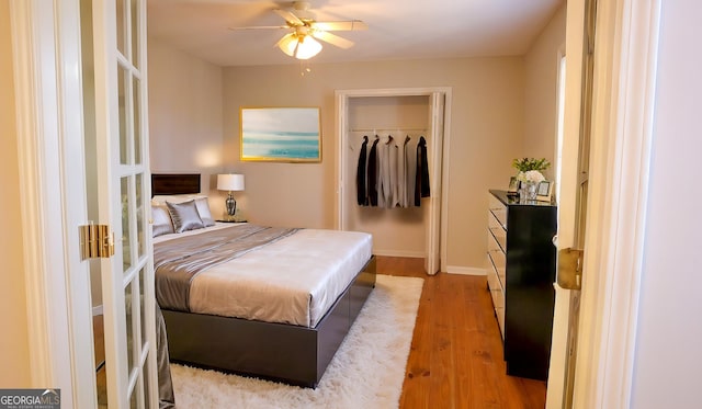 bedroom featuring ceiling fan, a closet, and hardwood / wood-style flooring