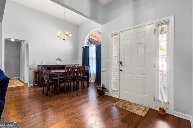 foyer featuring dark hardwood / wood-style flooring, plenty of natural light, and a notable chandelier