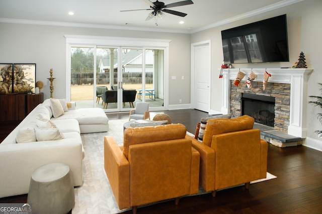 living room featuring a stone fireplace, crown molding, and dark hardwood / wood-style floors