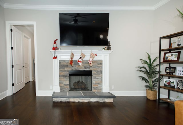 living room with dark wood-type flooring, a stone fireplace, and crown molding