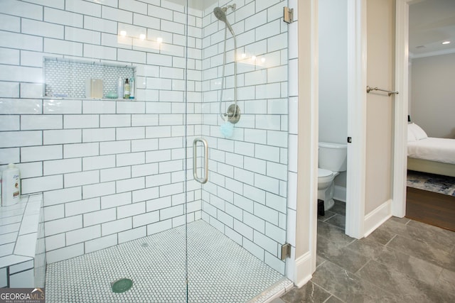 bathroom featuring toilet, an enclosed shower, and ornamental molding