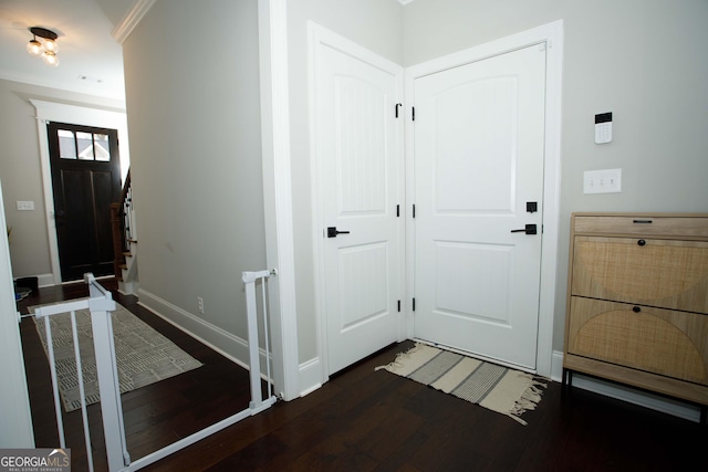 foyer featuring dark hardwood / wood-style floors and ornamental molding