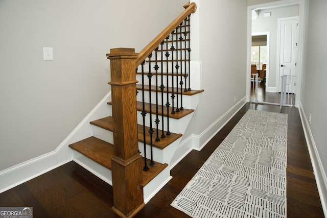 staircase with hardwood / wood-style flooring