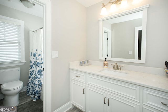 bathroom with vanity, toilet, and wood-type flooring