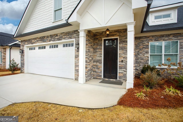 doorway to property with a garage