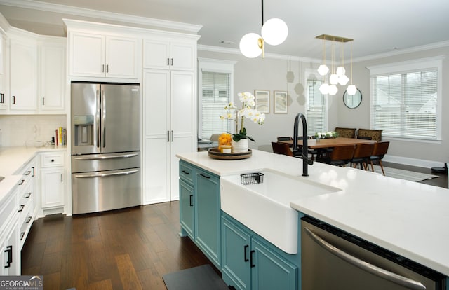 kitchen with sink, white cabinets, stainless steel appliances, and blue cabinets