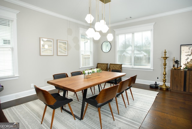 dining space featuring crown molding and dark wood-type flooring