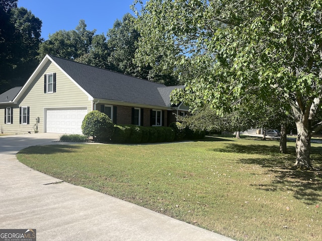 view of front of house featuring a garage and a front lawn