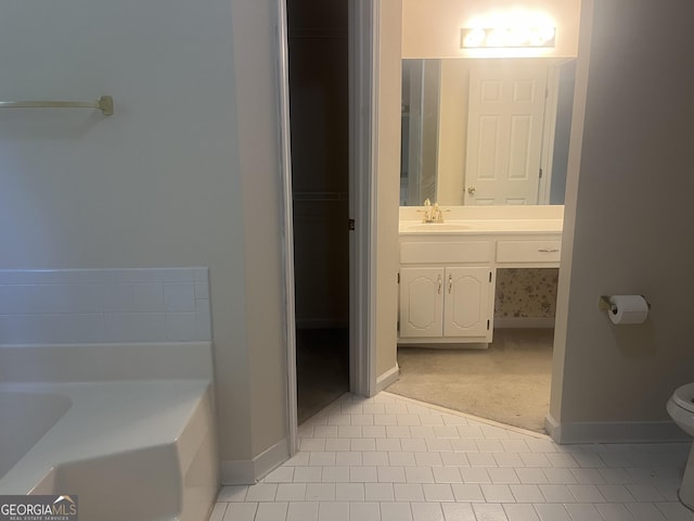 bathroom with tile patterned floors, a washtub, toilet, and vanity