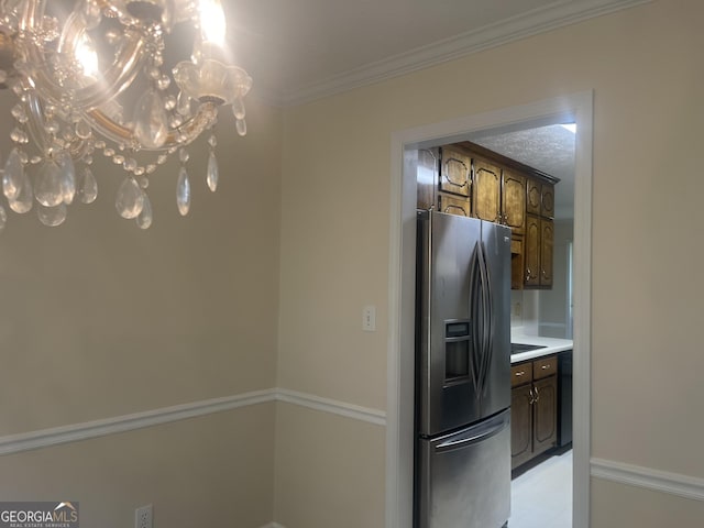 kitchen featuring dark brown cabinetry, stainless steel fridge, and ornamental molding