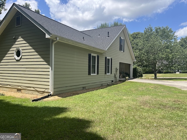 view of property exterior with a lawn and a garage