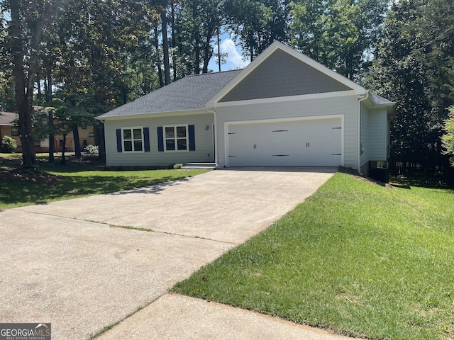 single story home featuring a garage and a front yard