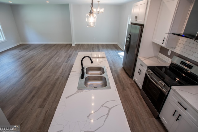 kitchen with backsplash, white cabinets, sink, light stone counters, and stainless steel appliances