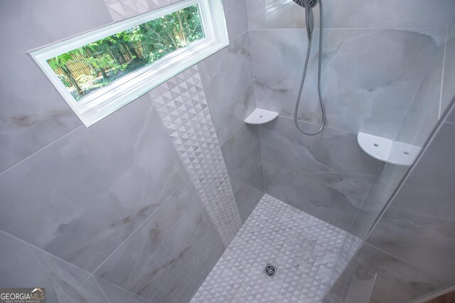 bathroom with a tile shower