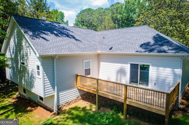 rear view of house featuring a wooden deck