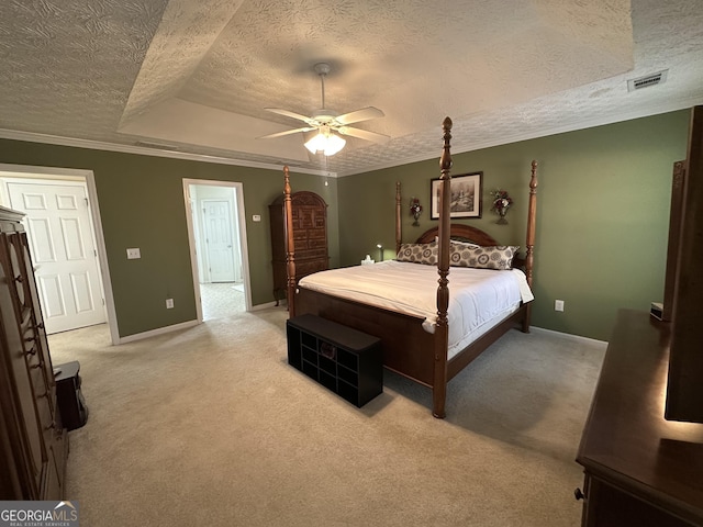 carpeted bedroom with a textured ceiling, ceiling fan, and crown molding