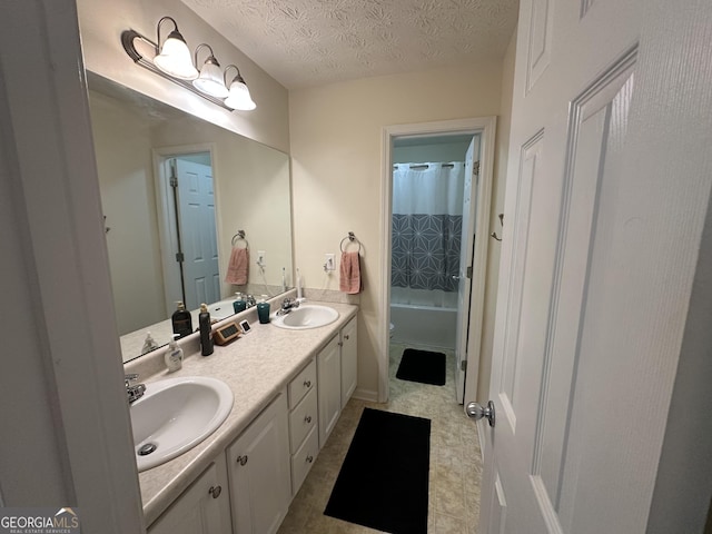 full bathroom with vanity, toilet, a textured ceiling, and shower / tub combo with curtain