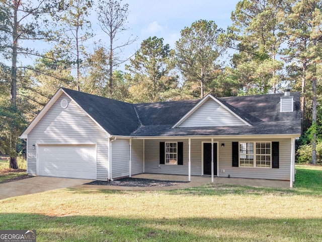 ranch-style house with covered porch, a garage, and a front yard