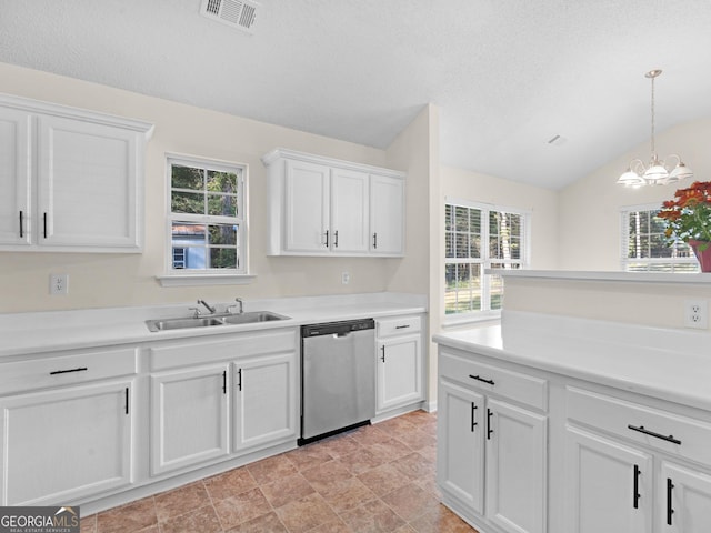 kitchen with white cabinetry, sink, stainless steel dishwasher, and lofted ceiling