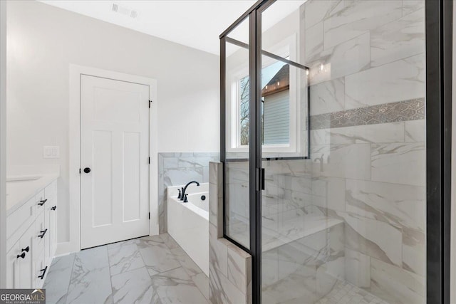 bathroom featuring vanity and independent shower and bath