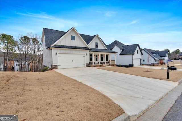 view of front of property with a front lawn, covered porch, and a garage